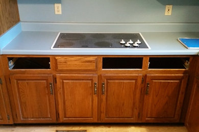 Inspiration for a small timeless l-shaped ceramic tile eat-in kitchen remodel in Birmingham with an undermount sink, raised-panel cabinets, medium tone wood cabinets, granite countertops, multicolored backsplash, mosaic tile backsplash, stainless steel appliances and an island