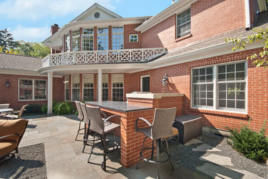 Large elegant backyard stone patio photo in Chicago with a fire pit and no cover