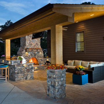 Outdoor fireplace with grill island and big green egg