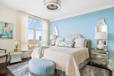 Example of a mid-sized beach style master dark wood floor and brown floor bedroom design in Other with blue walls and no fireplace