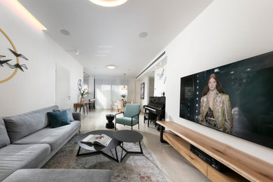 Example of a mid-sized trendy open concept ceramic tile and beige floor living room design in Other with beige walls and a wall-mounted tv