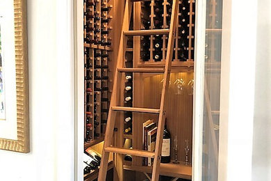 Inspiration for a small traditional wine cellar in Orlando with storage racks and beige floors.