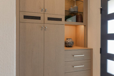 Trendy light wood floor and beige floor entryway photo in San Francisco with white walls and a glass front door