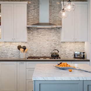 Mid-sized contemporary kitchen pantry remodeling - Inspiration for a mid-sized contemporary l-shaped porcelain floor and beige floor kitchen pantry remodel in San Diego with an undermount sink, recessed-panel cabinets, gray cabinets, solid surface countertops, beige backsplash, matchstick tile backsplash, stainless steel appliances, an island and white countertops