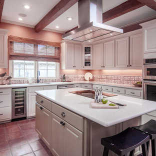 Mid-sized transitional kitchen pantry remodeling - Mid-sized transitional u-shaped terra-cotta floor kitchen pantry photo in New Orleans with quartz countertops, an island, white cabinets, beige backsplash, stainless steel appliances, an undermount sink and raised-panel cabinets