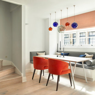 Small modern kitchen/dining room in London with grey walls, light hardwood flooring and beige floors.