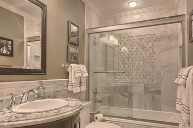 Example of a small classic white tile and stone tile marble floor bathroom design in St Louis with a drop-in sink, dark wood cabinets, granite countertops, a one-piece toilet, green walls and furniture-like cabinets