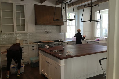 Example of a cottage kitchen design in Atlanta with white backsplash and ceramic backsplash