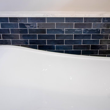 Primary Bathroom with Blue-Gray Vanity and Deep Blue Tiled Feature Wall