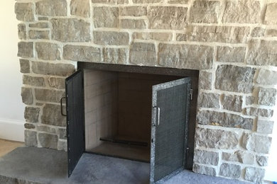 Custom Fireplace Front Featuring Mesh Screen and Grinder Finish