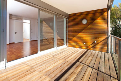 Inspiration for a mid-sized backyard deck remodel in San Francisco with a roof extension