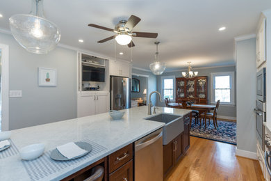 This is an example of a large classic l-shaped kitchen/diner in Richmond with a belfast sink, flat-panel cabinets, white cabinets, quartz worktops, blue splashback, mosaic tiled splashback, stainless steel appliances, light hardwood flooring, an island, brown floors, grey worktops and a drop ceiling.