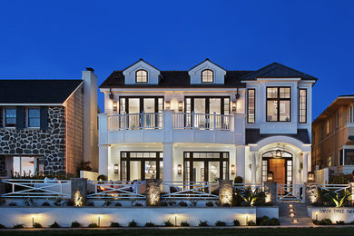 This is an example of a beach style three-storey white exterior in Orange County.