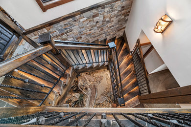 Photo of a large country wood floating staircase in Other with open risers and mixed railing.