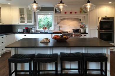 Kitchen - large traditional medium tone wood floor kitchen idea in Seattle with an undermount sink, soapstone countertops, white backsplash, subway tile backsplash and stainless steel appliances