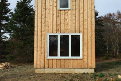 Inspiration for a small modern two-story wood gable roof remodel in Other
