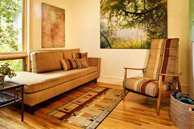 Example of a small formal and open concept medium tone wood floor living room design in Minneapolis