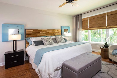 Inspiration for a large master medium tone wood floor bedroom remodel in Other with gray walls and no fireplace