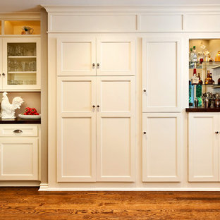 Mid-sized traditional kitchen pantry appliance - Mid-sized elegant medium tone wood floor kitchen pantry photo in Portland with recessed-panel cabinets and white cabinets