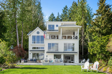 Coastal white four-story clapboard exterior home idea in Seattle with a metal roof and a gray roof