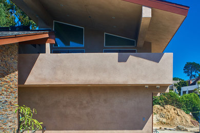 Photo of a contemporary two-storey stucco exterior in San Diego with a shed roof.