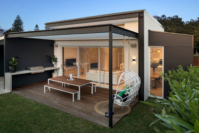 Inspiration for a small beach style one-storey white house exterior in Adelaide with a flat roof and a metal roof.