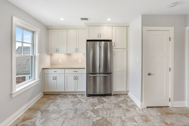 Enclosed kitchen - mid-sized contemporary l-shaped enclosed kitchen idea in New York with beaded inset cabinets, white cabinets and no island