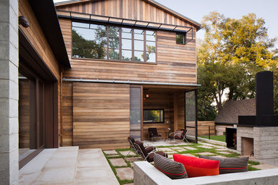 Huge trendy two-story wood exterior home photo in Austin