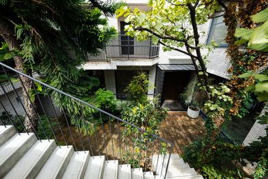 Cette photo montre une grande terrasse moderne avec une cour et des pavés en brique.