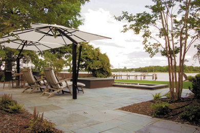 Patio - large contemporary backyard concrete paver patio idea in Baltimore with a fire pit and a gazebo