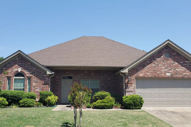 Example of a mid-sized classic red one-story brick house exterior design in Little Rock with a hip roof, a shingle roof and a brown roof