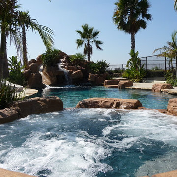Rock Swimming Pool with Slide, Waterfall and a Table in the pool.