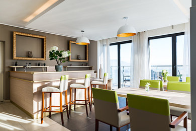 This is an example of a large contemporary l-shaped breakfast bar in Turin with beaded cabinets, light wood cabinets, wood worktops, porcelain flooring, beige floors and multicoloured worktops.