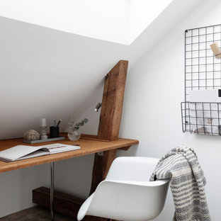 Inspiration för ett litet skandinaviskt hemmabibliotek, med vita väggar, mellanmörkt trägolv, ett inbyggt skrivbord och brunt golv