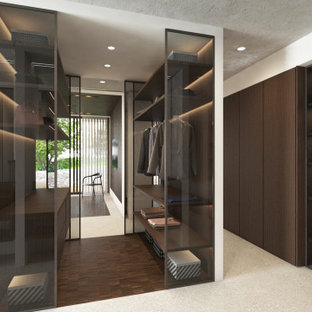 Modelo de armario vestidor unisex, contemporáneo, grande, con armarios tipo vitrina, puertas de armario de madera en tonos medios, suelo de baldosas de porcelana y suelo gris