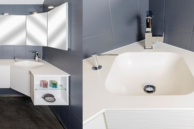 Пример оригинального дизайна: ванная комната среднего размера в современном стиле с врезной раковиной и столешницей из искусственного камня