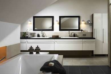 Photo of a large contemporary bathroom in Other with white cabinets and white walls.