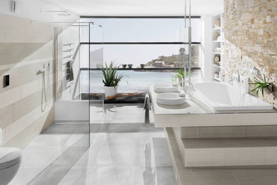 Inspiration for a large contemporary bathroom in Other with a vessel sink, tiled worktops, a built-in bath, a walk-in shower, grey tiles, ceramic tiles, grey walls, ceramic flooring, open cabinets, white cabinets and an open shower.