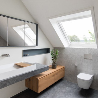 Mittelgroßes Modernes Duschbad mit hellen Holzschränken, bodengleicher Dusche, weißer Wandfarbe, flächenbündigen Schrankfronten, Wandtoilette, beigefarbenen Fliesen, Zementfliesen, Zementfliesen, grauem Boden und Trogwaschbecken in Frankfurt am Main
