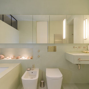 Ispirazione per una stanza da bagno contemporanea di medie dimensioni con vasca sottopiano, bidè, pareti verdi, ante con bugna sagomata, ante verdi, doccia a filo pavimento, pavimento verde, doccia aperta, lavabo integrato, nicchia e un lavabo