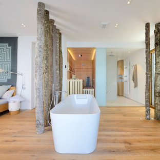 Inspiration for a large contemporary bathroom in Other with flat-panel cabinets, light wood cabinets, a freestanding tub, beige tile, ceramic tile, white walls, medium hardwood floors, a vessel sink, wood benchtops and with a sauna.