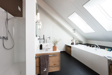 Large contemporary bathroom in Other with medium wood cabinets, a freestanding bath, a built-in shower, black tiles, ceramic tiles, white walls, ceramic flooring, a vessel sink and solid surface worktops.