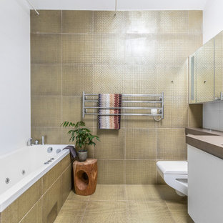 Inspiration för mellanstora moderna brunt badrum, med släta luckor, vita skåp, en dusch/badkar-kombination, en vägghängd toalettstol, beige kakel, gul kakel, ett platsbyggt badkar, vita väggar och gult golv
