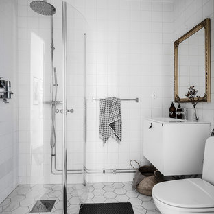 Idéer för ett minimalistiskt badrum med dusch, med släta luckor, vita skåp, en hörndusch, en toalettstol med separat cisternkåpa, vit kakel, vita väggar, grått golv och dusch med gångjärnsdörr