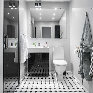 Inspiration för mellanstora minimalistiska badrum med dusch, med släta luckor, svarta skåp, en toalettstol med hel cisternkåpa, vita väggar, flerfärgat golv, en dusch i en alkov, cementgolv, ett konsol handfat och dusch med gångjärnsdörr