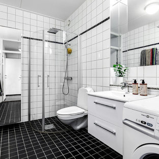 Exempel på ett stort skandinaviskt badrum med dusch, med släta luckor, vita skåp, svart golv, en hörndusch, en toalettstol med separat cisternkåpa, svart kakel, svart och vit kakel, flerfärgad kakel och vit kakel