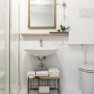 Ispirazione per un bagno di servizio nordico con nessun'anta, WC a due pezzi, pareti bianche, lavabo sospeso e pavimento bianco