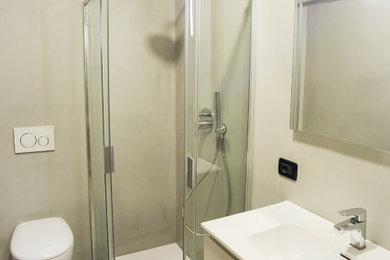 Esempio di una piccola stanza da bagno con ante bianche, WC sospeso, lavabo integrato, top bianco e mobile bagno sospeso