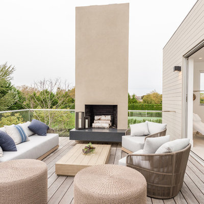 Balcony - huge contemporary glass railing balcony idea in New York with a fire pit and no cover