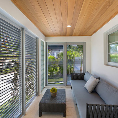 Mid-sized trendy glass railing balcony photo in Miami with a roof extension